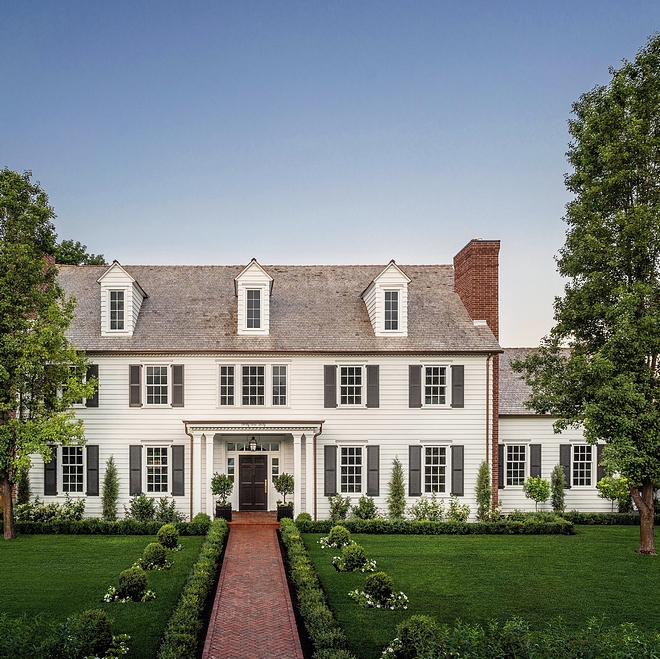 White Classic Colonial Home with Black shutters, herringbone brick pathway and brick chimney #ClassicColonial #ColonialHome #Blackshutters #herringbonebrick #brickpathway #pathway #brickchimney