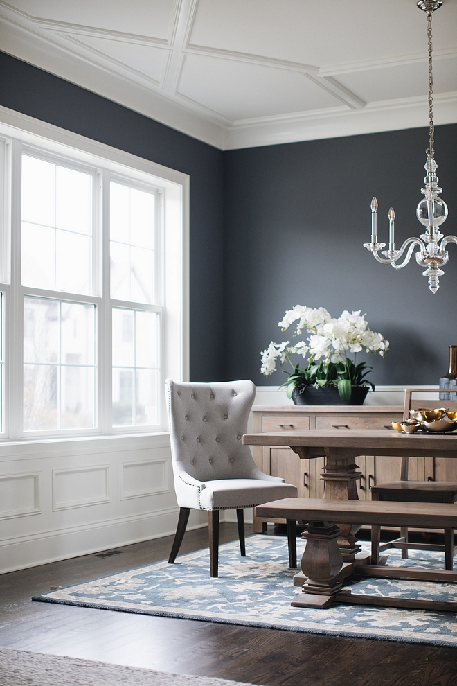 White wainscoting , trim and ceiling paint color is Benjamin Moore Simply White with dark charcoal walls painted in Benjamin Moore Charcoal Slate #BenjaminMooreSimplywhite #trim #wainscoting #ceiling #millwork #Darkcharcoaldiningroom #diningroom #wallpaintcolor