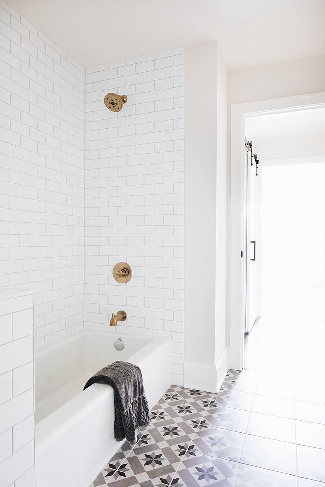 Kids bathroom featuring white subway tile bathtub and grey and beige cement tile as flooring #kidsbathroom #cementtile