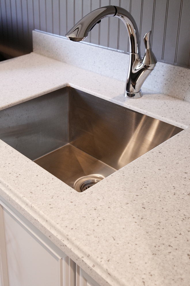 Laundry room countertop is Silver Birch ½’ Corian with soft Ogee Edge. Backsplash is beadboard