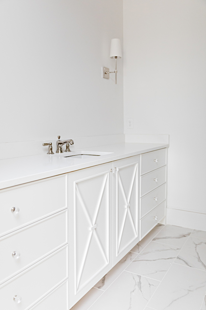White vanity Bathroom cabinetry is inset flat paneled slabs with x detail Paint color is Sherwin Williams SW 7004