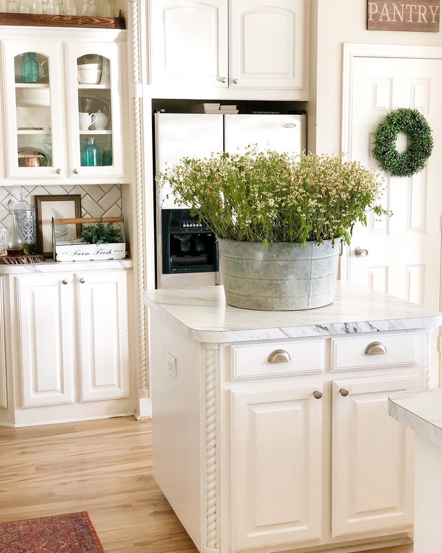 Kitchen cabinets are painted in Glidden Grab-and-go for high traffic areas in semi-gloss white