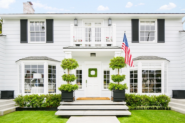 White home exterior with black shutters and black planters by front door Classic curb-appeal #Whitehome #whiteexterior #whiteexteriors #blackshutters #planters #frontdoor #Classiccurbappeal #curbappeal
