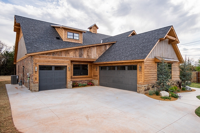 Sherwin Williams Iron Ore This home features very interesting architectural details and it certainly feels like a rustic mountain home A three-car garage is located on the left wing of the house Garage doors are painted in Sherwin Williams Iron Ore Sherwin Williams Iron Ore #SherwinWilliamsIronOre