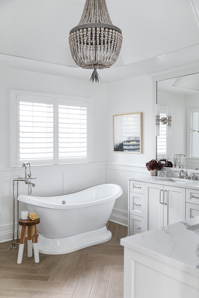 White bathroom with wainscoting White bathroom with wainscoting and wood-looking tile in herringbone pattern White bathroom with wainscoting White bathroom with wainscoting #Whitebathroom #bathroomwainscoting