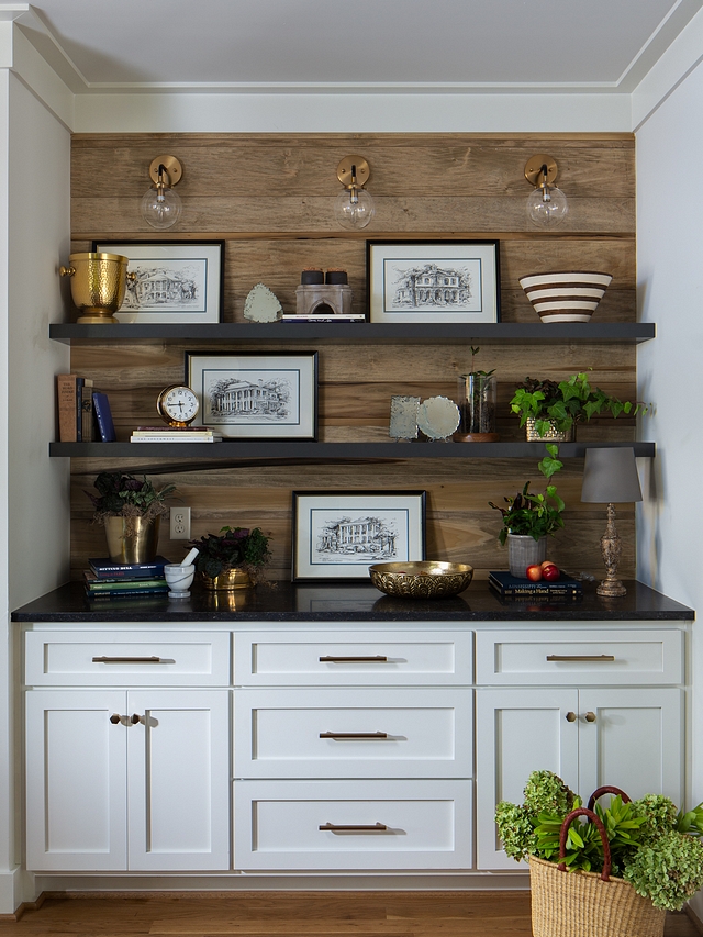 This drop-off zone features the same off-white cabinet, shiplap backplash and honed Belgium Bluestone countertop. Floating shelves are custom and cabinetry is painted in Sherwin Williams Greek Villa #cabinetry #dropoffzone #floatingshelves #shiplap #backplash #reclaimedshiplap
