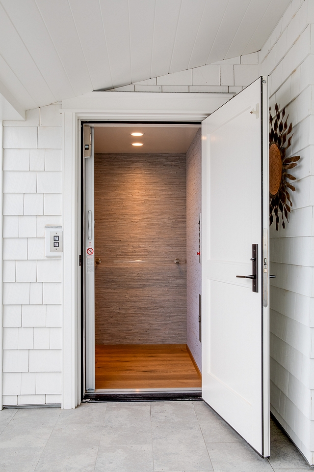 An elevator leads you to the rooftop. The elevator features Hartman and Forbes wallpaper and an acrylic handle #residentialelevator #elevator