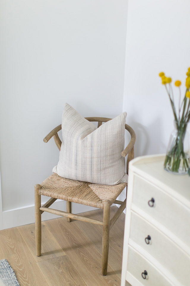 Wishbone style accent chair with vintage pillow