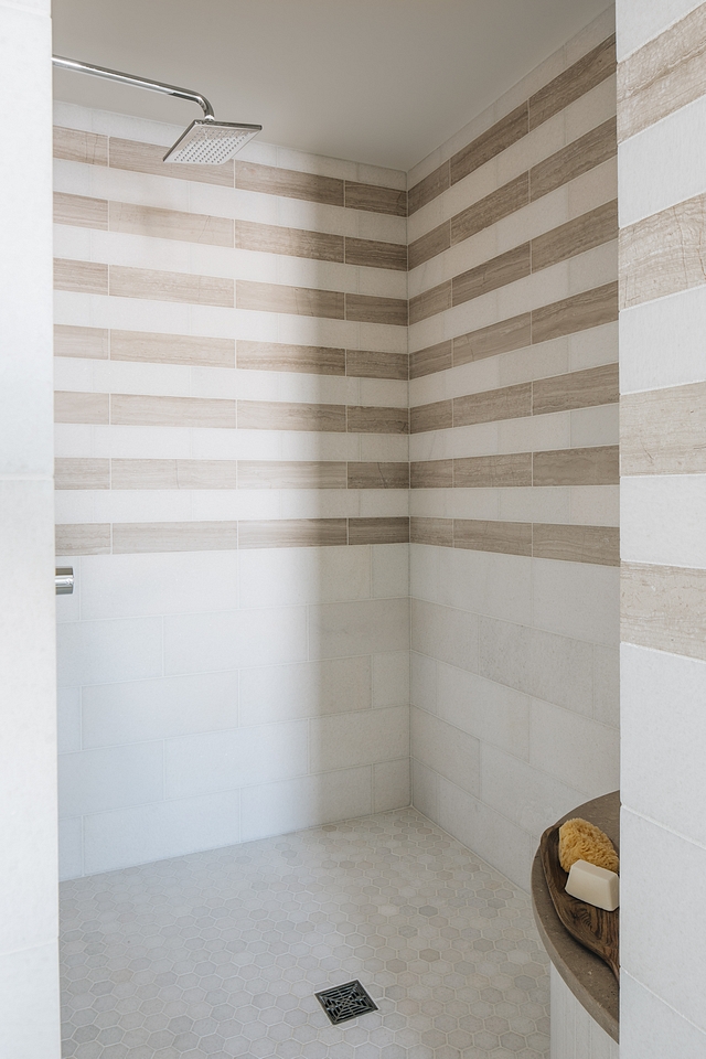 Shower tile I loved creating the stripe pattern in the shower to look like wallpaper above a chair rail. There are so many details in this master suite but the shower tile detail is my favorite #showertile #showertilepattern #tilepattern #tile