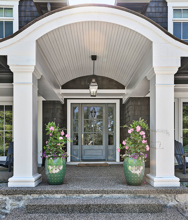 Arched porch ceiling The porch features custom columns and arched ceiling The grey front door with sidelights was custom-painted in a dark grey shade #porch #frontporch #porchcolumns #frontdoor #Archedporchceiling #porchceiling #archedporch
