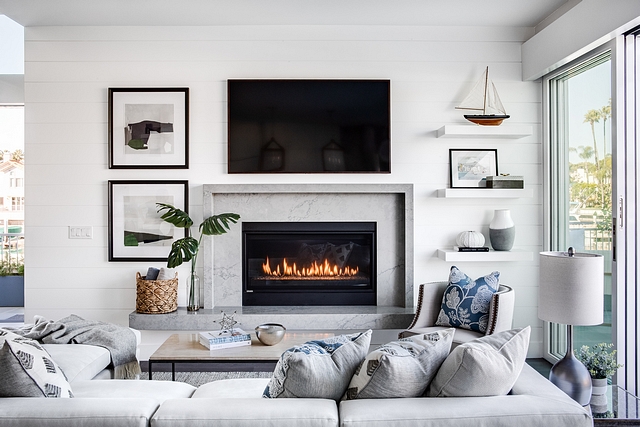 Sleek marble fireplace with shiplap accent wall Living room featuring a Sleek marble fireplace with shiplap accent wall Sleek marble fireplace with shiplap accent wall #Sleekmarblefireplace #fireplace #marblefireplace #shiplap #accentwall