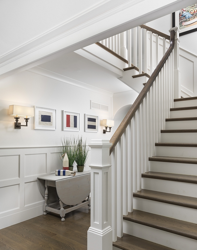 Traditional Staircase The spindles on the stairs have a simple classic Arts and Crafts line. We painted the spindles and newel posts and contrasted the handrail and staircase treads to match the wood stain on the plank flooring #traditionalstaircase #staircase