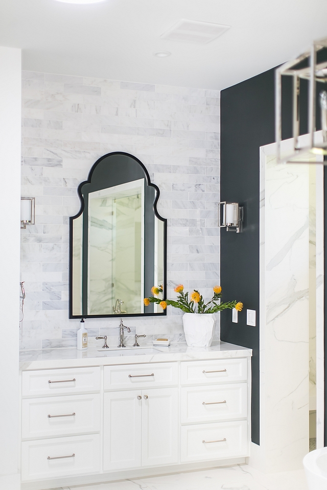 Arched Mirror Bathroom with white marble subway tile backsplash accentuated by a black arched mirror #archedmirror #bathroom #mirror #bathroommirror