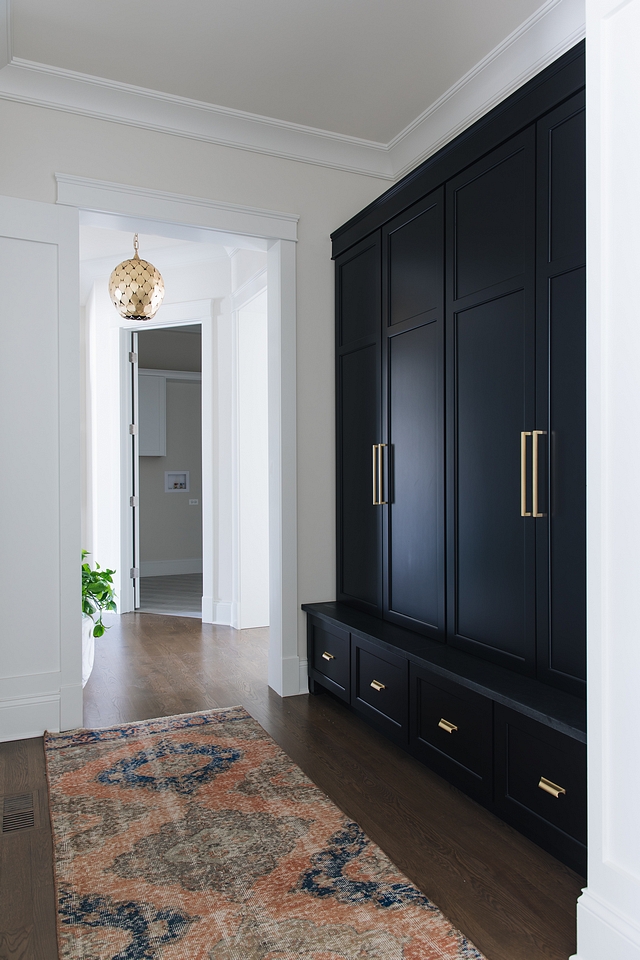 Black Mudroom Cabinet Black by Benjamin Moore The black mudroom cabinet is painted in Benjamin Moore Black and it features Honed Absolute Granite ledge Black cabinet with brass hardware #Blackmudroom #blackcabinet #blackpaintcolor #Blackcabinetwithbrass