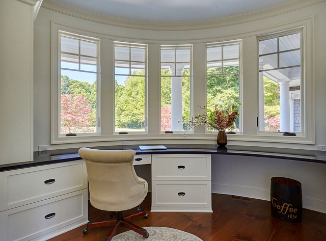 Curved Wall Curved wall home office Set inside the curved turret is a home office with traditional shaker cabinetry and dark stone countertops #CurvedWall #homeoffice