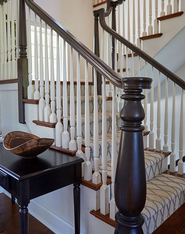 Staircase The staircase was custom designed and it features open end swell step with 7" custom starting newel post, . 1-1/4" painted balusters, Poplar handrail stained in a dark brown color. The staircase treads are Southern yellow pine with a custom carpet runner #staircase #treads #baluster #newelpost