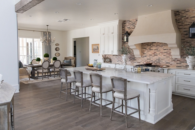 French Farmhouse Kitchen Combining brick backsplash with White Marble countertops, this French-farmhouse kitchen feels connected with the rest of the house and it features a timeless design #Frenchfarmhouse #Frenchkitchen #Farmhosuekitchen #brickbacksplash #whitemarble #countertop #timelesskitchendesign