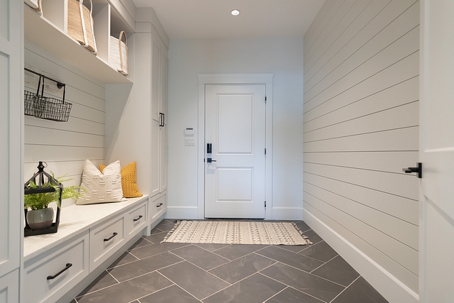 Farmhouse Mudroom Shiplap Dark large-scale herringbone floors with light grout distract from the dirt that is ever-present in our mud room #mudroom #shiplap #mudroomtile
