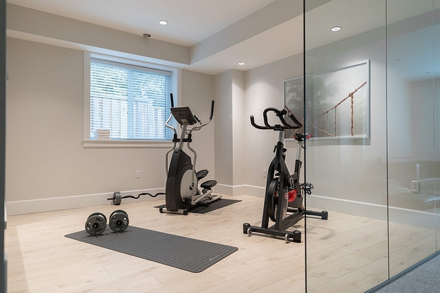Home Gym The first question people ask when they see this room is, “do you actually use your gym?” Why yes, yes we do! We added 3 large glass panels, so this room doesn’t feel closed off from the rest of the basement #homegym