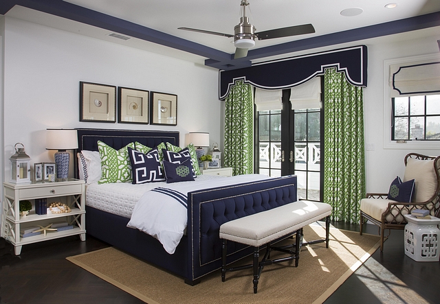 Featuring a navy blue and Kelly green color scheme, this master bedroom exudes a timeless and far-from-boring approach #bedroom #masterbedroom #colorscheme #bedroomcolorscheme