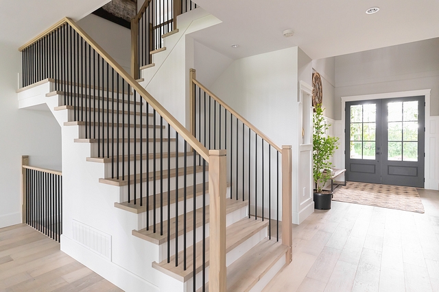 Wood Staircase Treads Instead of carpet I opted for hardwood stairs with white risers. I shifted away from the thick and heavy spindles and selected thin rails and posts. These white oak posts are only 4” wide #staircasetreads #staircase #stairwell #treads