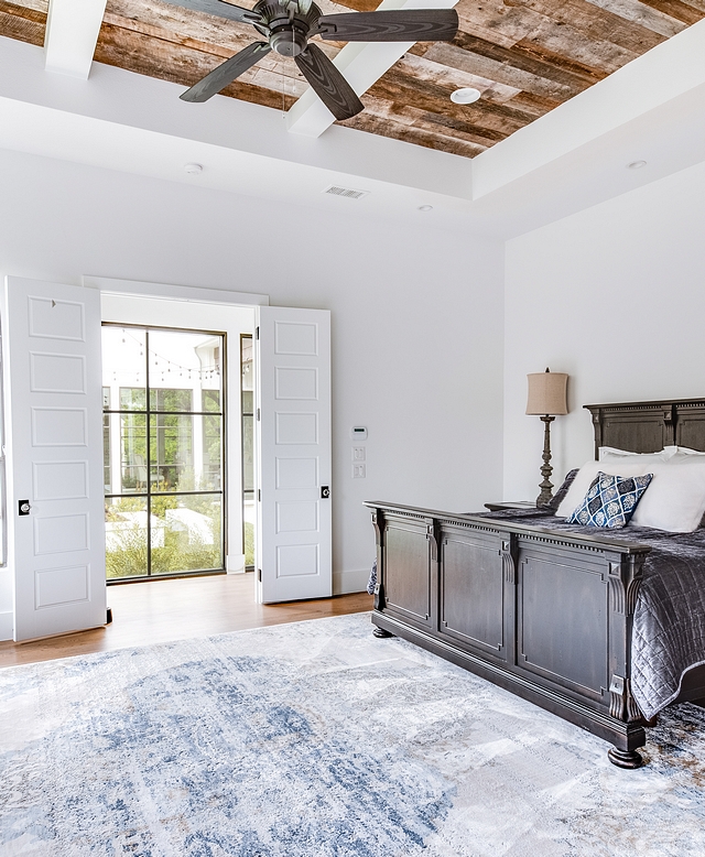 The master bedroom was kept simple to give emphases to the architectural details such as the reclaimed barnwood ceiling #barnwood #bedroom #masterbedroom