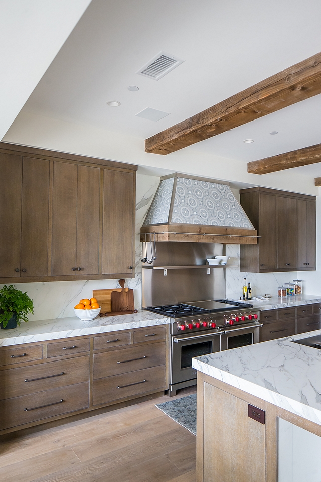 Mediterranean kitchen Modern Mediterranean kitchen with tiled Hood, ceiling beams and Rift Oak cabinets with custom grey stain #Mediterraneankitchen #Mediterraneaninteriors #ModernMediterraneankitchen #tiledhood #ceilingbeams #kitchenbeams #RiftOakcabinets #greystaincabinet