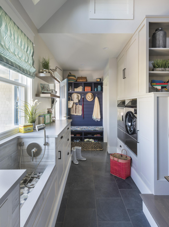 This pet-friendly laundry/mudroom comes with a very practical dog-washing station. The area also doubles as a utility sink for sandy sneakers and swimsuits. Cubbies are painted in Black Flame by Olympic Paint. Also notice that the washer and dryer are elevated on back-saving pedestals