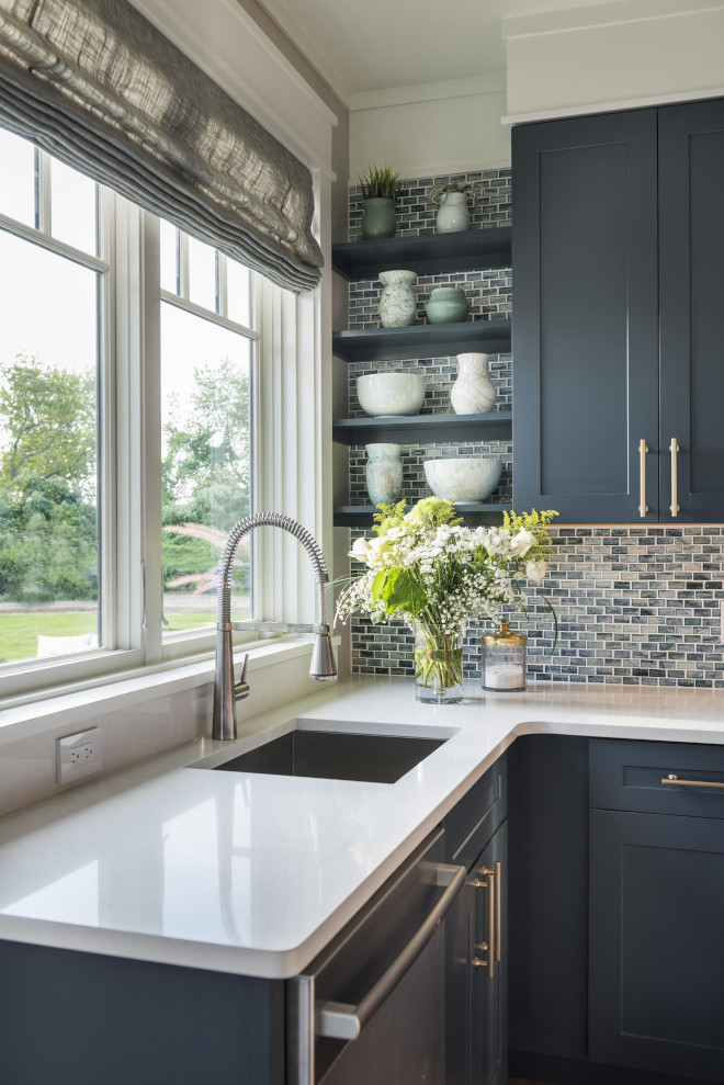 Navy blue kitchen with white quartz countertop