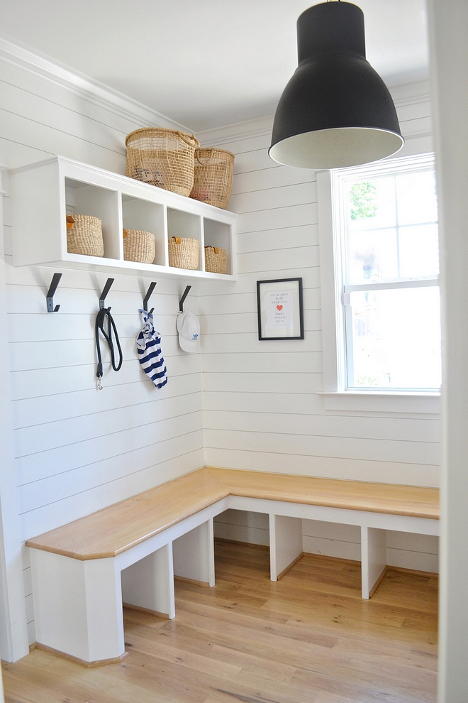 The mudroom features a custom L-shaped bench with Oak seating