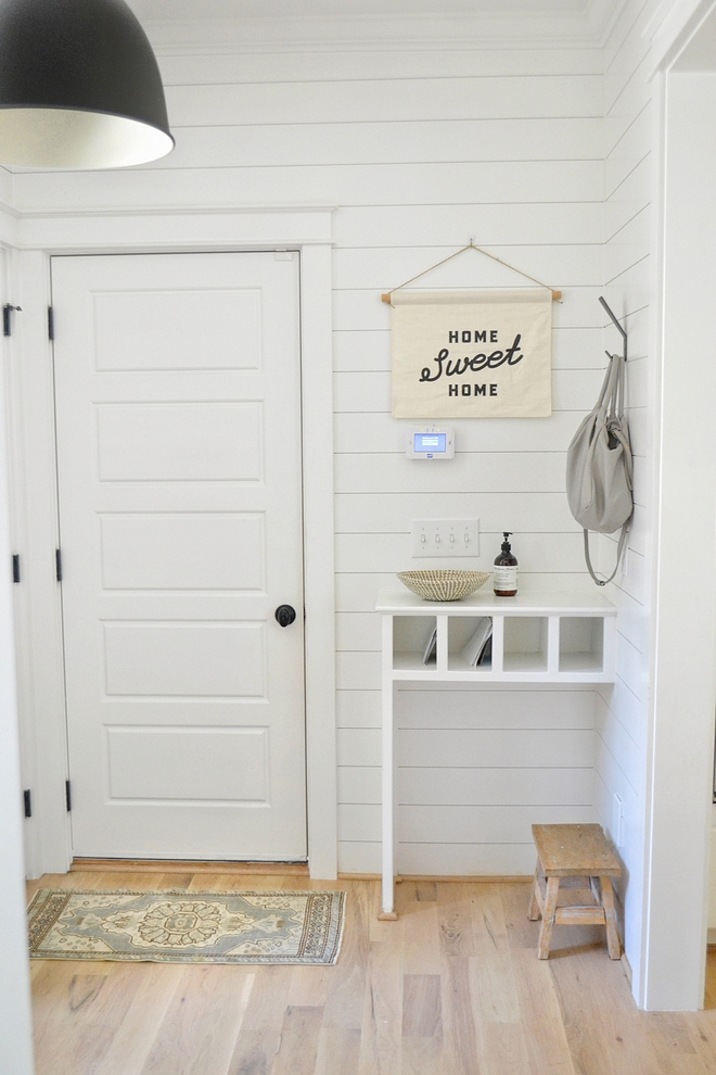 This beautiful mudroom also features a custom drop-zone/desk area