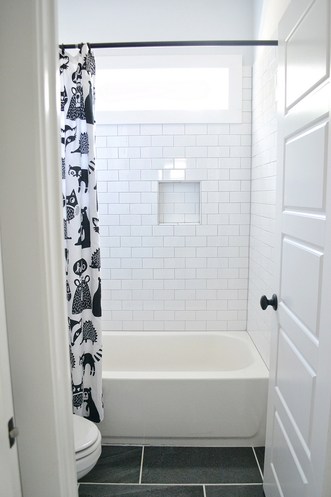 Shower tile is subway tile with gray grout 