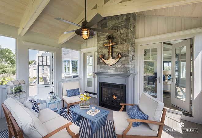 A screened-in porch with fireplace extends the living space of this home
