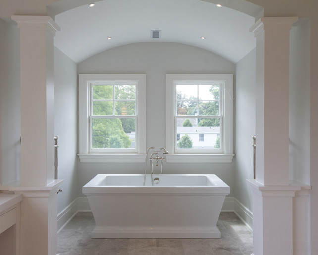 Barrel Ceiling Bath Nook. This master bath boasts heated marble floors, wrap around vanity make-up table with custom mosaic feature wall, steam shower and an air-jetted freestanding spa bath situated in a columned tub alcove. #masterBathroom #Bathroom #BarrelCeiling #Alcove #Nook #bath Blue Water Home Builders.