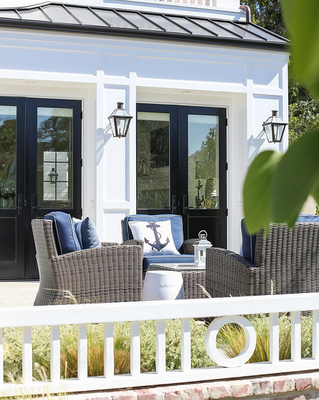 Patio Decorating Ideas. Coastal Patio Decorating Ideas. Beautiful patio with wicker furniture, navy blue cushions to coordinate with the anchor pillows. #patio #Furniture #Coastal #CoastalDecor Brandon Architects. Ryan Garvin photographer. Patterson Custom Homes.