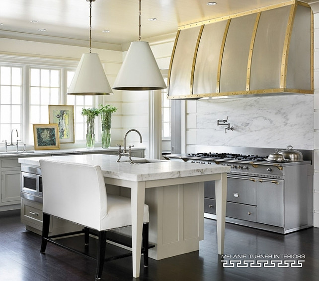 Transitional Industrial Kitchen. Transitional kitchen with kitchen features light gray cabinets paired with honed white marble countertops and a white tongue and groove backsplash and Two Goodman Hanging Lamps. #Transitional #KItchen #Industrial Melanie Turner Interiors.