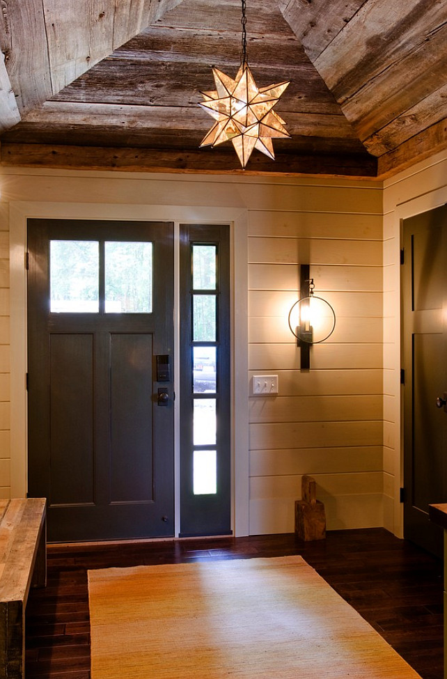 Rustic Foyer with reclaimed Wood ceiling. The wall sconce is the Visual Comfort Gilded Iron with Wax Suzanne Kasler 1 Light Alice Wall Sconce in Aged Iron. The pendant is the Moravian Star Pendant. Barn wood ceiling. Barn wood ceiling foyer. #ReclaimedWood #BarnWood #Ceiling #Foyer Kristina Crestin Design.