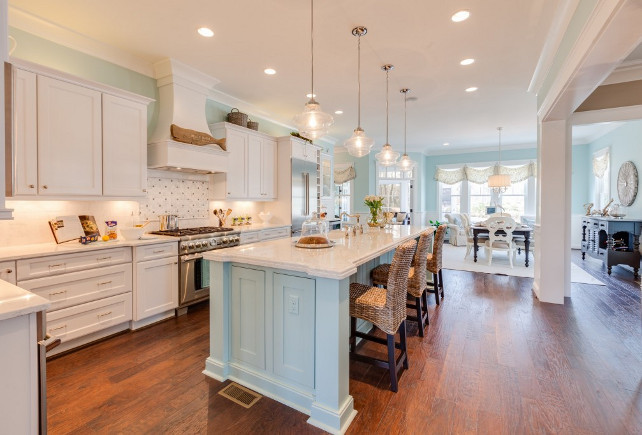Blue Kitchen with white cabinets. The kitchen is made bright with on-trend clear glass pendants from the Progress Lighting Academy collection. The simple school house shape adds to the kitchen's simple chic appeal. 