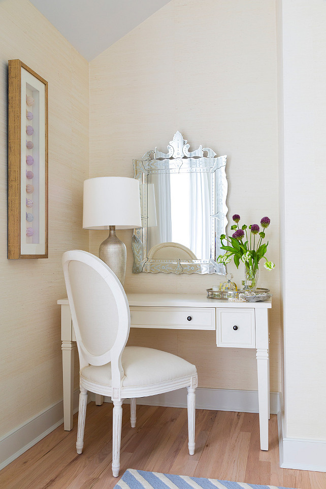 Master bedroom vanity area. Venetian mirror and artwork featuring sea urchins displayed on wall. Louis style chair and white vanity. Grasscloth wallpaper on all walls. #Vanity #Bedroom #VanityArea #MasterBedroom Chango & Co. 