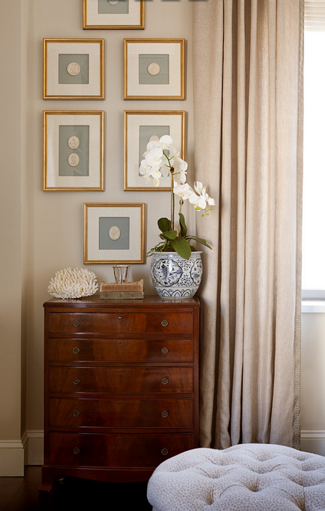 Art above dresser. Elegant space features an antique chest placed under a collection of art in gold leaf frames. #Dresser #Art Jenny Wolf Interiors.