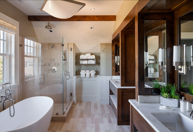 Transitional Bathroom Design. This transitional bathroom is full of inspirational ideas, including the large double vanities with dark stained wood and white marble. #BathroomDesign #BathroomIdeas #BathroomVanity