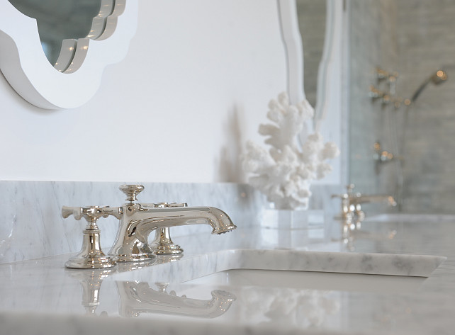 Bathroom countertop. Bathroom countertop ideas. Bathroom features polished white marble countertop with polished nickel bathroom faucet. #Bathroom
