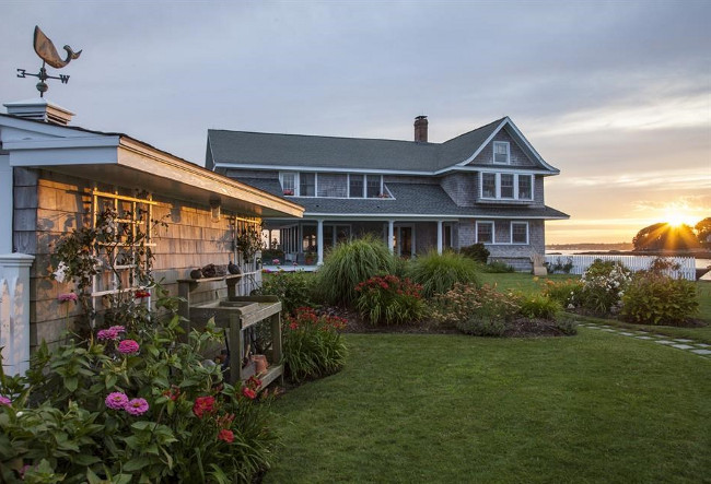 Beach house with garden shed with weather vane. Christie's Real Estate.