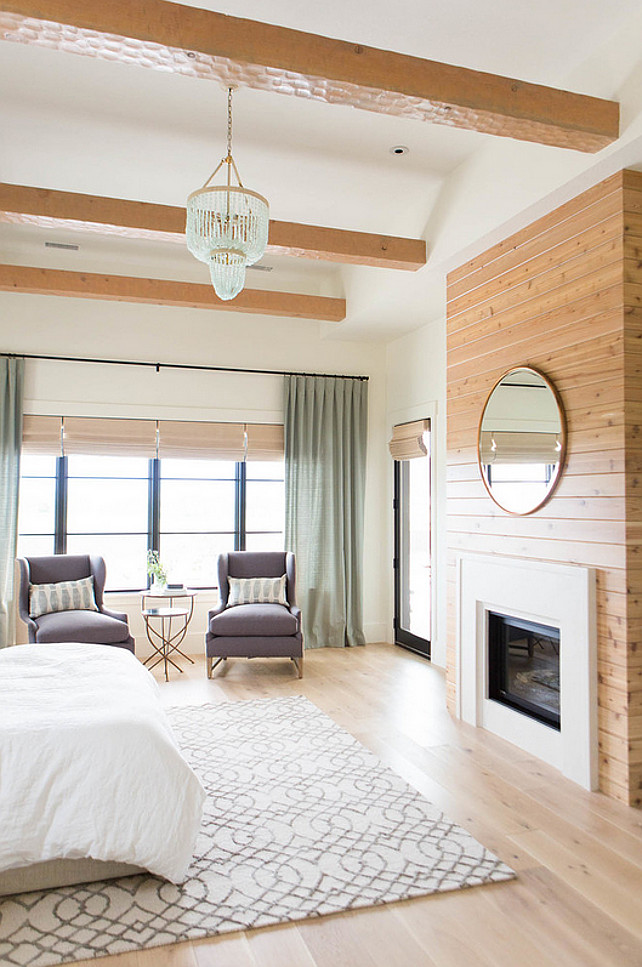 Bedroom. Master Bedroom Fireplace. Master bedroom with fireplace, seating area, ceiling beams and seafoam coastals chandelier. #Bedroom #MasterBedroom #FireplaceAshley Winn Design.