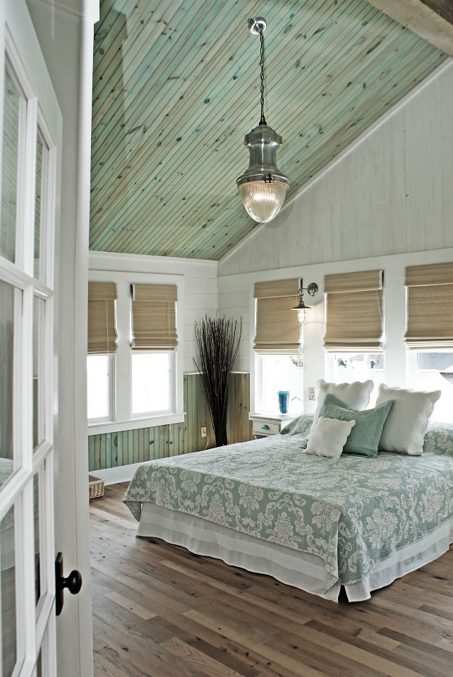 Bedroom. Coastal Bedroom. Aqua Bedroom. Coastal aqua bedroom. The ceiling wood is finished with highly diluted aqua tint to give it just a hint of color and left without varnish to assure the wood looks natural and that there is no reflection. The light fixture is the Vintage Streetlight Prism Pendant from Restoration Hardware. The bed linens are from Manuel Canovas. The window shades are Extreme Woven Lorena Natural 27 w/ White Edge Binding & White BO Liner. #Bedroom #Aqua #PaintColor #Coastal
