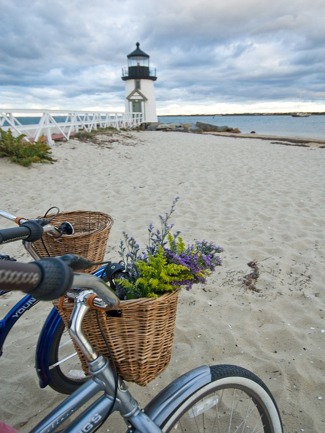 Bike on the beach. Vintage bike on the beach with flower basket. Lighthouse.