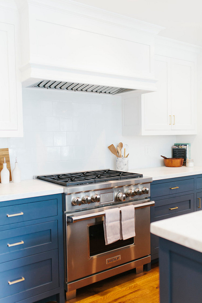 This navy blue and white kitchen features white 6x6 tile backsplash. #glossywhite #6x6Tiles #Backsplash Shea McGee Design.