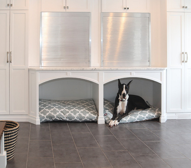 Built-in Dog Beds. Mudroom. Mudroom with Built-in Dog Beds, cabinets and aluminum garage doors for storage. #BuiltinDogBed #DogBed #Mudroom Redstart Construction.