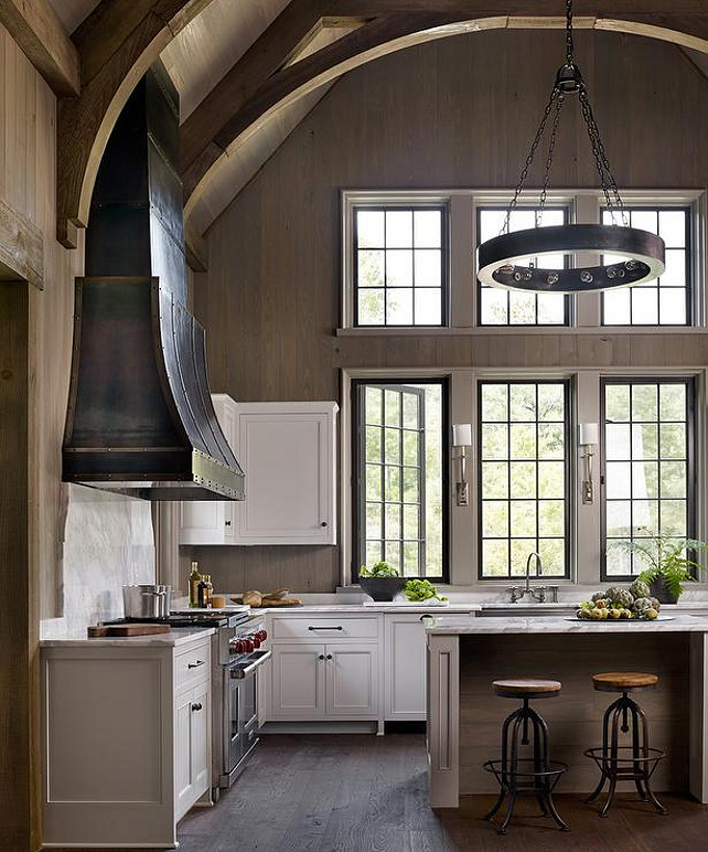 Cathedral Ceiling Kitchen Ideas. Kitchen with cathedral ceiling design. Three steel swing-out windows hang over a stainless steel apron sink and Ruhlmann Single Sconces. #Kitchen #CathedralCeiling #KitchenCathedralCeiling Dungan Nequette.