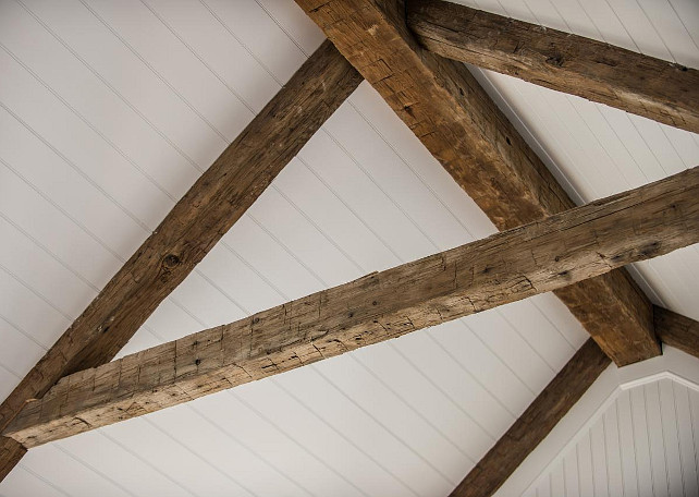 Ceiling Beams. The antique beams combine with a classic beadboard ceiling to create interest and add cottage charm to the gorgeous white great room #CeilingIdeas #AntiquedBeams #ReclaimedBeams
